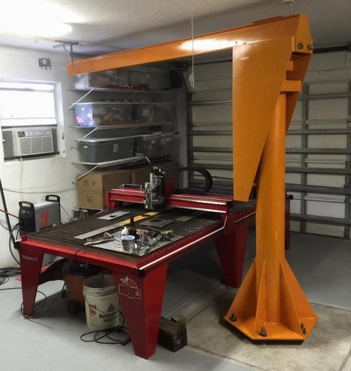 A cutting table and crane comprise a workshop in a garage.